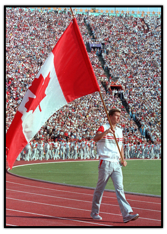 Alex Baumann carrying the Canadian flag