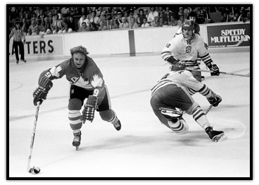 Bobby Hull carries the puck with one hand on his stick