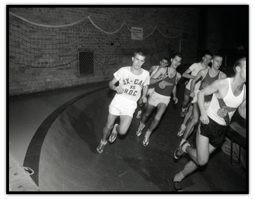 Bruce Kidd running on an indoor track