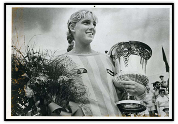 Carling Bassett with a trophy and flowers