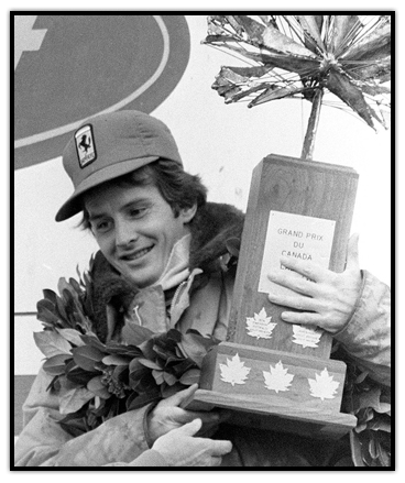 Gilles Villeneuve holding a trophy for winning the Canadian Grand Prix
