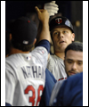 Justin Morneau is congratulated in the dugout after hitting a home-run