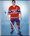 Portrait of Maurice Richard in his uniform holding a stick