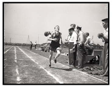 Rich Ferguson running on the outside lane of a track