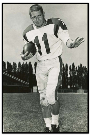 Ron Stewart posing with a football