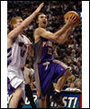 Steve Nash with the basketball while being defended by Matt Bonner of the Toronto Raptors