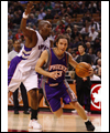 Steve Nash dribbles past Eric Williams