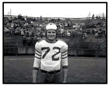 Tony Golab on a football field with his helmet